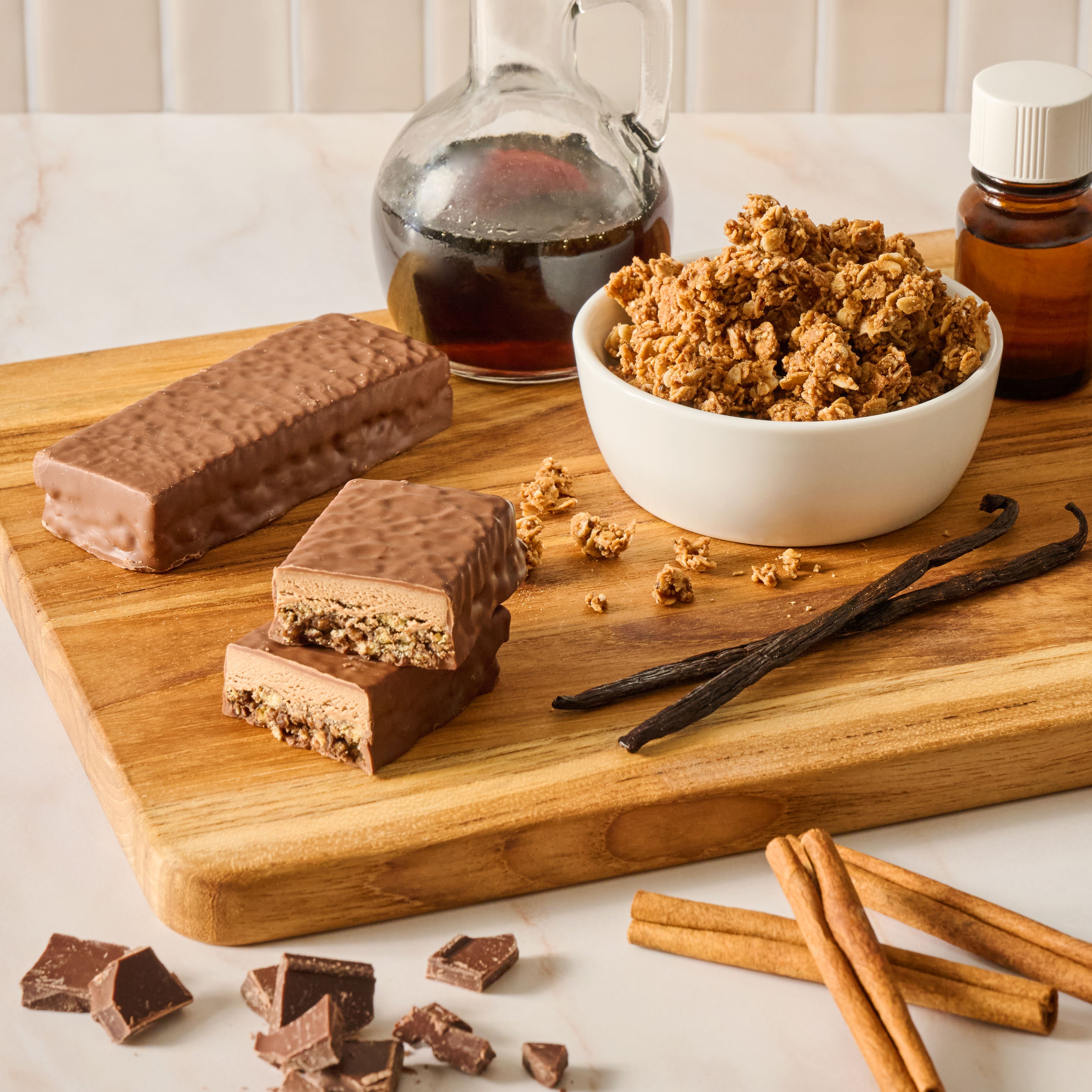 Image of snack bars and cereal surrounded by various syrups and ingredients.