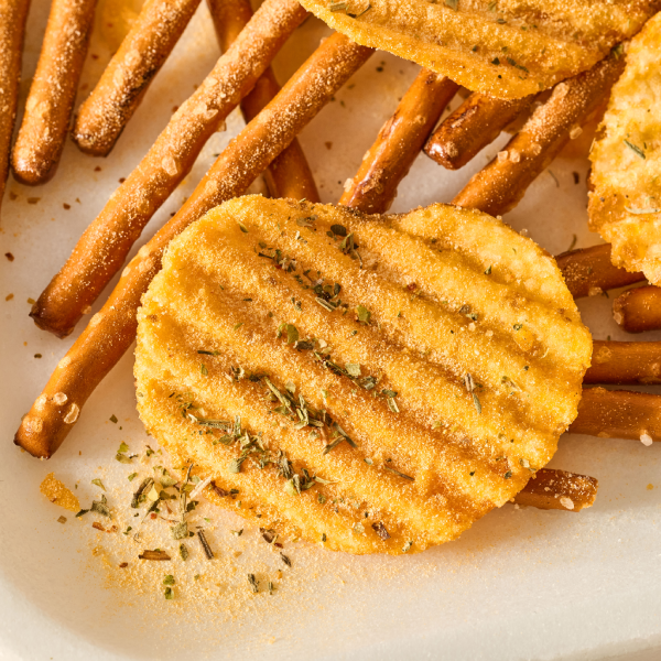 Close up shot of chips and pretzels with seasoning