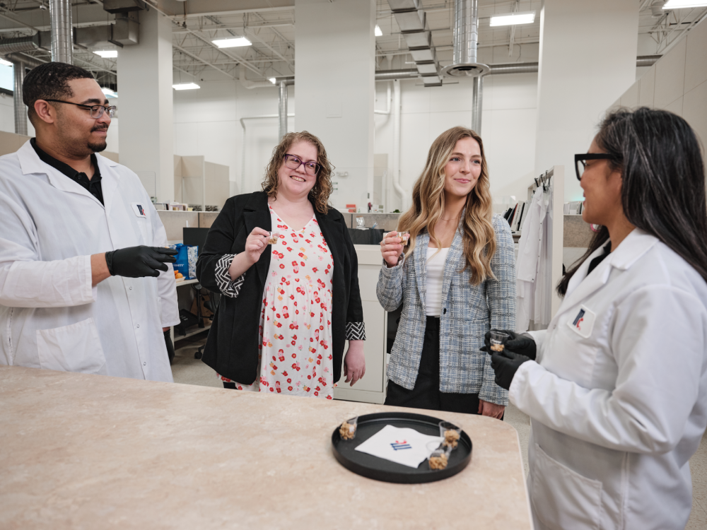 A group of people collaborating on a granola taste test.